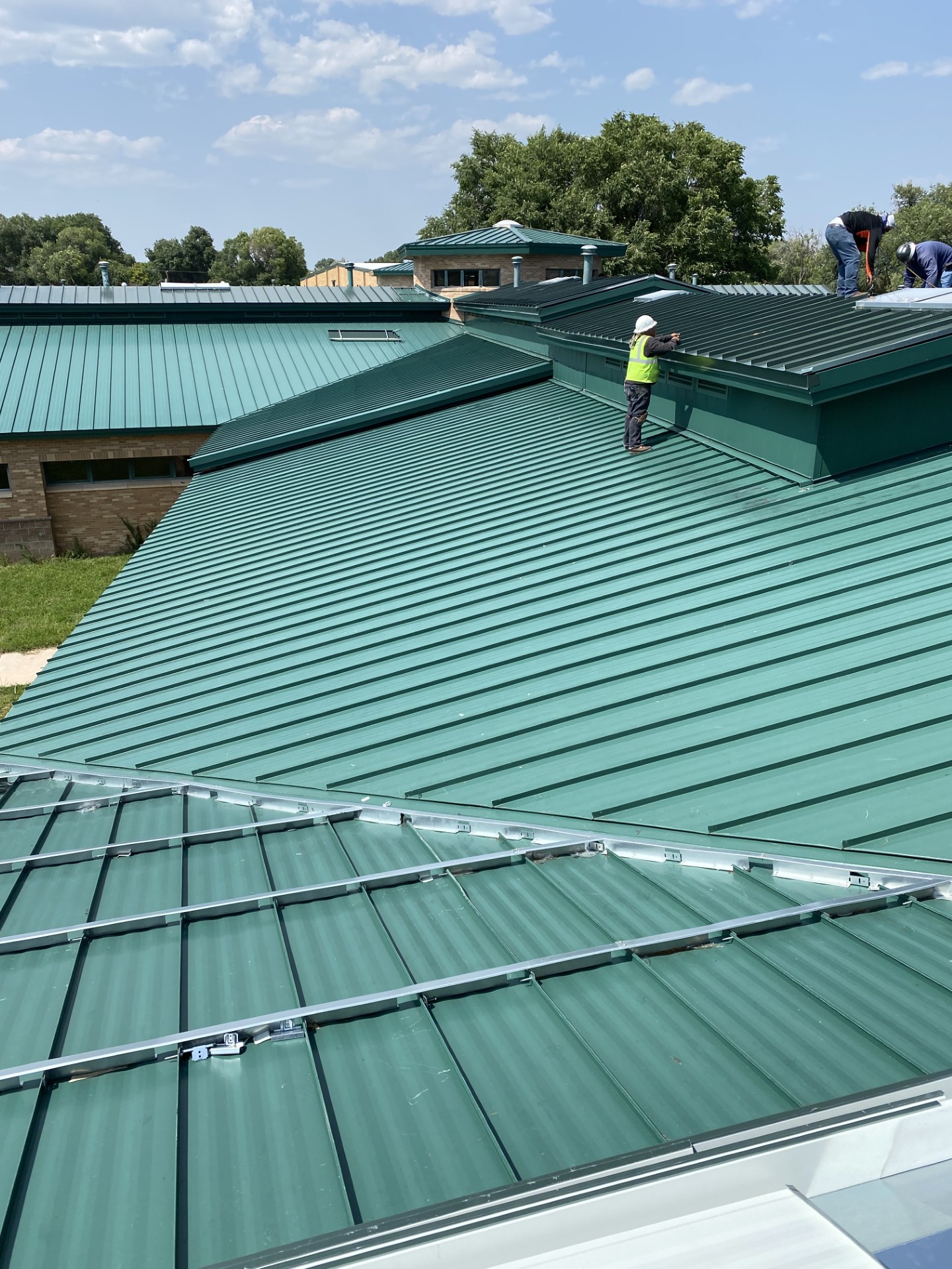 Green standing seam metal roof on a building
